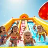 Excited children sliding down a bright water slide rental, creating splashes of water and joy.