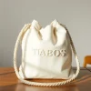 Showcasing a stylish Cotton Rope Bag on a wooden surface, highlighting its unique texture and eco-friendly design.