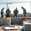 Constructing footing and block walls with skilled workers in a vibrant outdoor setting.