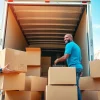 Efficient Canadian movers expertly loading boxes into a truck, showcasing teamwork and reliability.