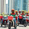 Dynamic scene of delivery apps in Lagos featuring vibrant riders and bustling streets.