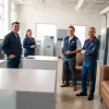 HVAC dealers demonstrating energy-efficient systems in a professional showroom environment.