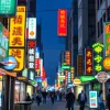 Illuminated electrical signs in a busy urban setting, showcasing vibrant designs.