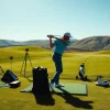Golfer using golf training aids to enhance swing technique at a sunny driving range.