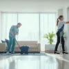 Professionals performing bond cleaning Logan in a bright apartment, enhancing cleanliness and appeal.