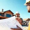 Custom home builders near me discussing a construction project with architectural plans.