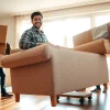 Queens movers expertly relocating furniture with care in a bright, welcoming living space.