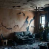 Evaluate fire damage restoration processes with professionals in a devastated home.