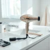 Stylish hair dryer showcased on a modern vanity in a bright bathroom environment.