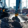 Performing hydro eexcavation nc with advanced equipment in an urban construction site setting.