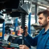 Technician replacing shock absorber in a professional Taller amortiguadores workshop, showcasing precision and expertise.