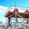 Workers constructing durable Whangarei scaffolding on a busy construction site.