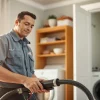 Technician cleaning dryer vents near me in a comfortable home environment to ensure safety.