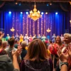 Experience a vibrant atmosphere of matinee vegas with lively performers and an engaged audience.