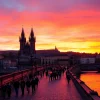 Visitors experiencing the beauty of Charles Bridge Prague during a stunning sunset.