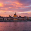 Capture the stunning Budapest skyline at dusk with illuminated buildings and the Danube River shimmering.