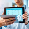 Engaged healthcare provider utilizing cloud based eprescribing software on a digital tablet in a modern clinic.